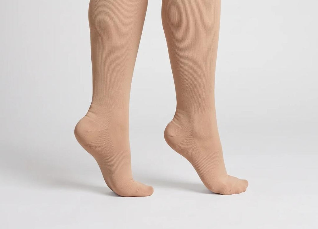 Chaussettes de compression graduée beiges hauteur genou portées